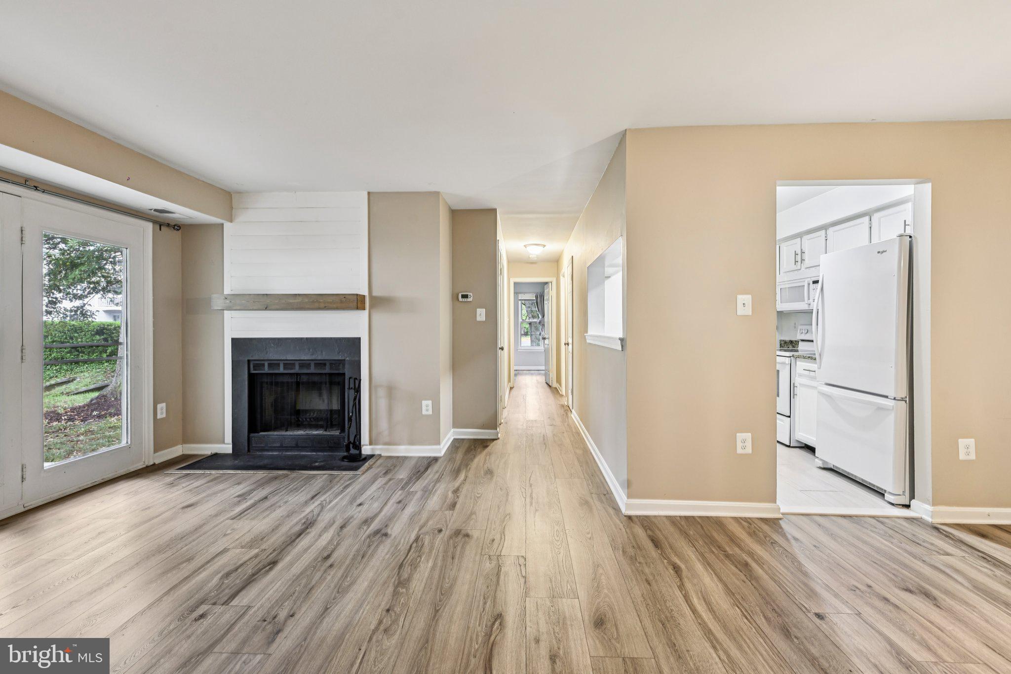 5707 Olde Mill Court, Unit 111 Alexandria, VA 22309 - Photo 5 of 32 a view of a livingroom with wooden floor and a fireplace
