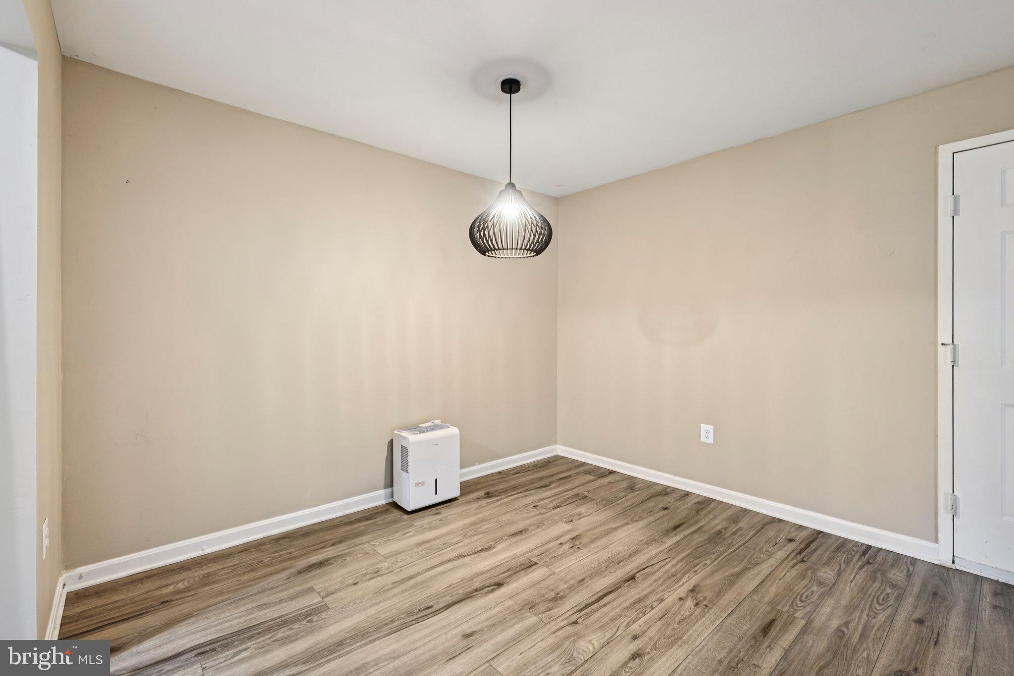5707 Olde Mill Court, Unit 111 Alexandria, VA 22309 - Photo 7 of 32 a view of a room with wooden floor and fan