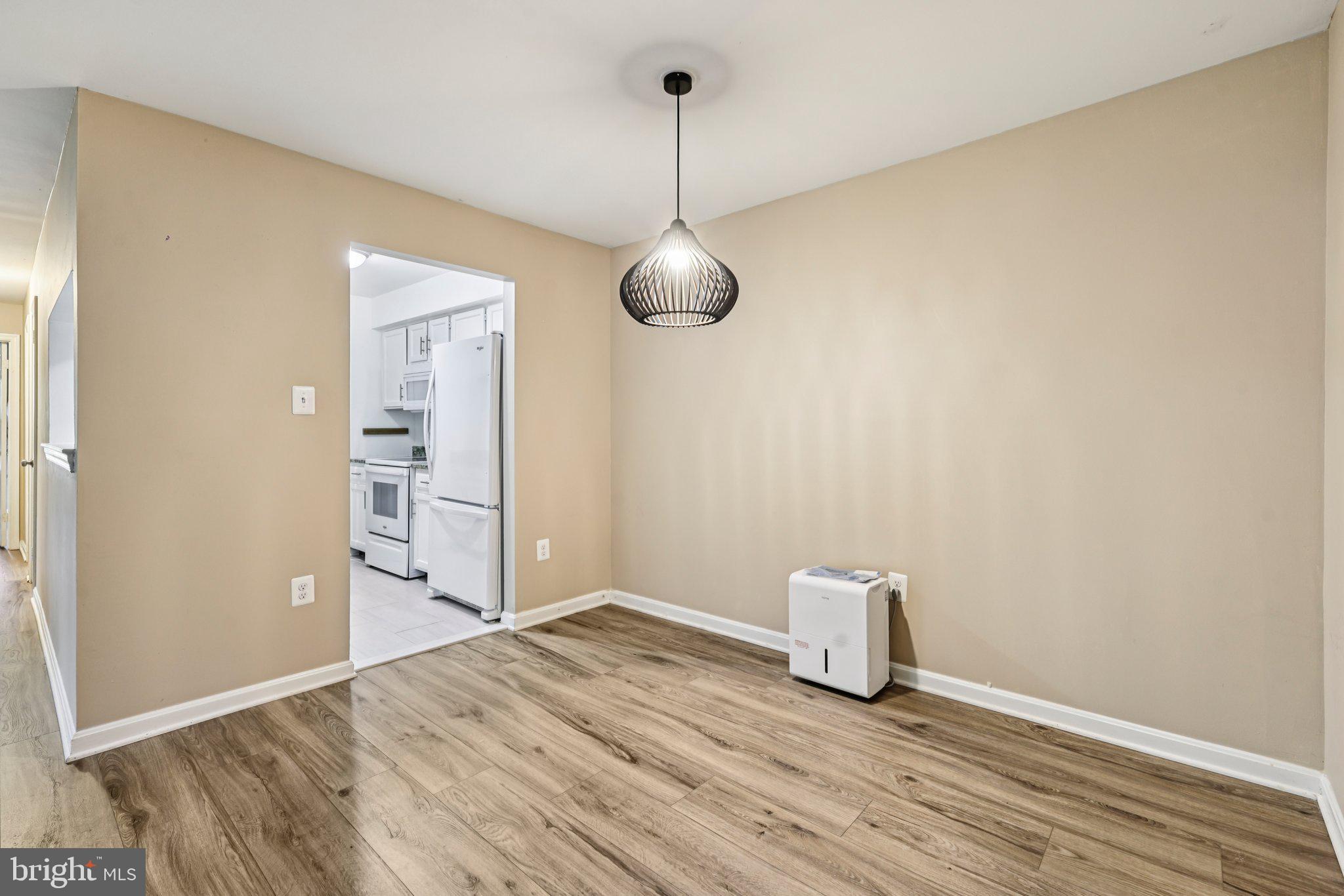 5707 Olde Mill Court, Unit 111 Alexandria, VA 22309 - Photo 8 of 32 a view of empty room with wooden floor