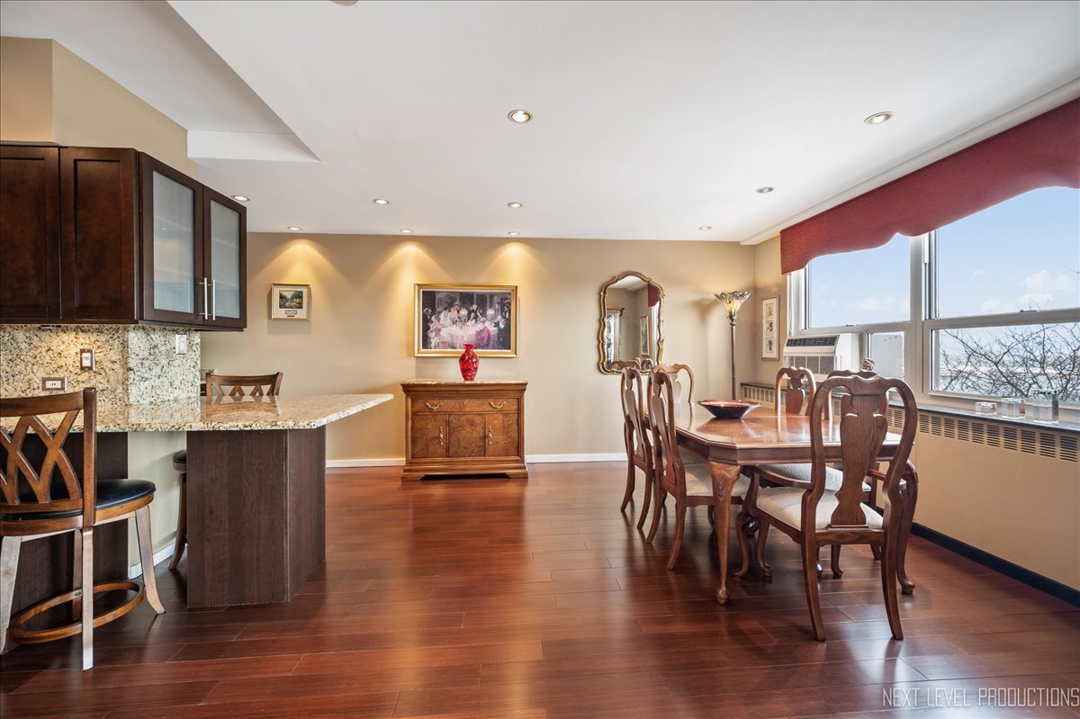 3180 North Lake Shore Drive, Unit 5E Chicago, IL 60657 - Photo 13 of 28 a view of a dining room with furniture and wooden floor