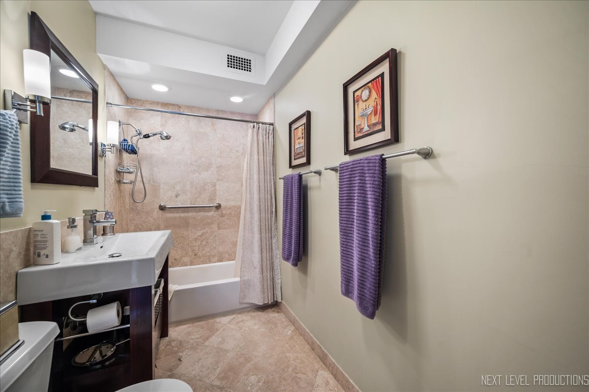 3180 North Lake Shore Drive, Unit 5E Chicago, IL 60657 - Photo 18 of 28 a bathroom with a sink and a mirror