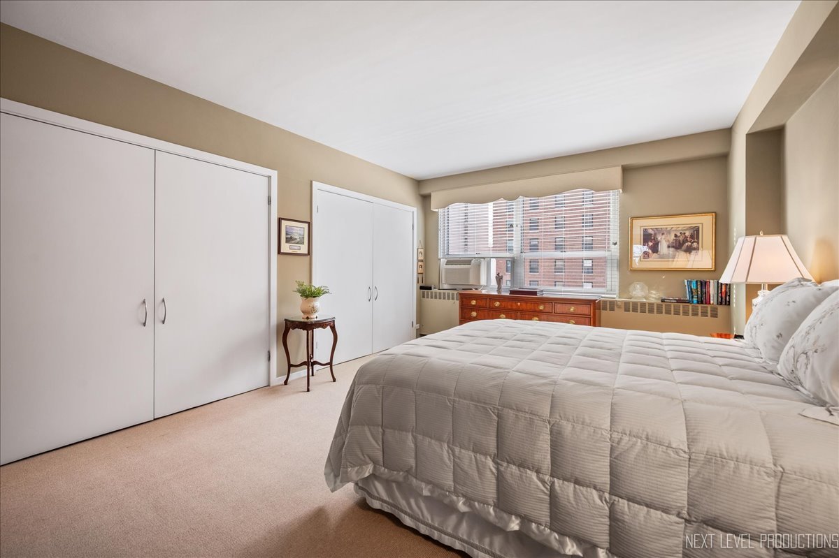 3180 North Lake Shore Drive, Unit 5E Chicago, IL 60657 - Photo 20 of 28 a bedroom with a bed and a large window