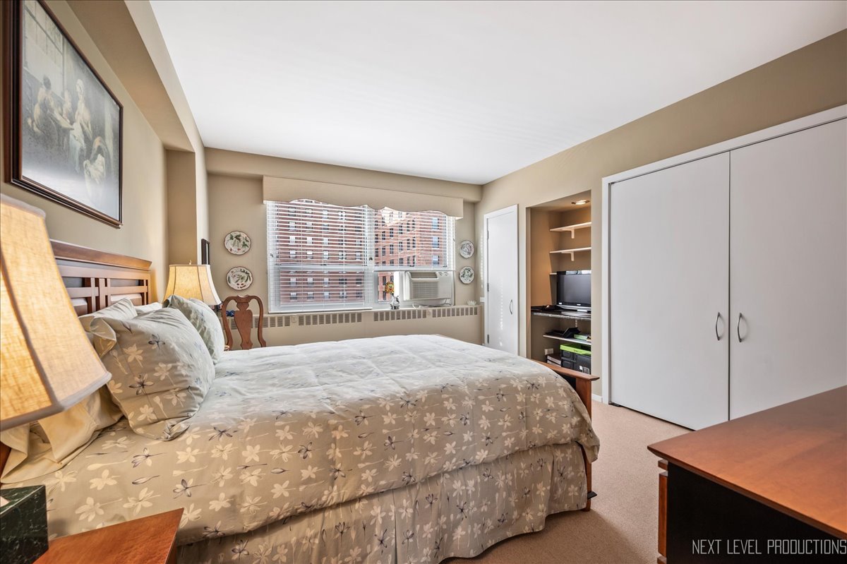 3180 North Lake Shore Drive, Unit 5E Chicago, IL 60657 - Photo 22 of 28 a bedroom with a large bed and a window