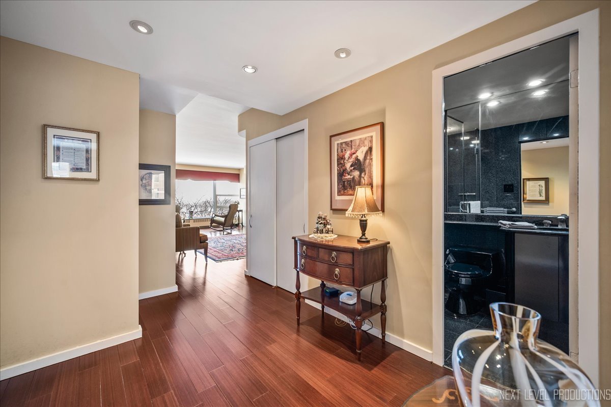 3180 North Lake Shore Drive, Unit 5E Chicago, IL 60657 - Photo 5 of 28 a living room with furniture and a wooden floor