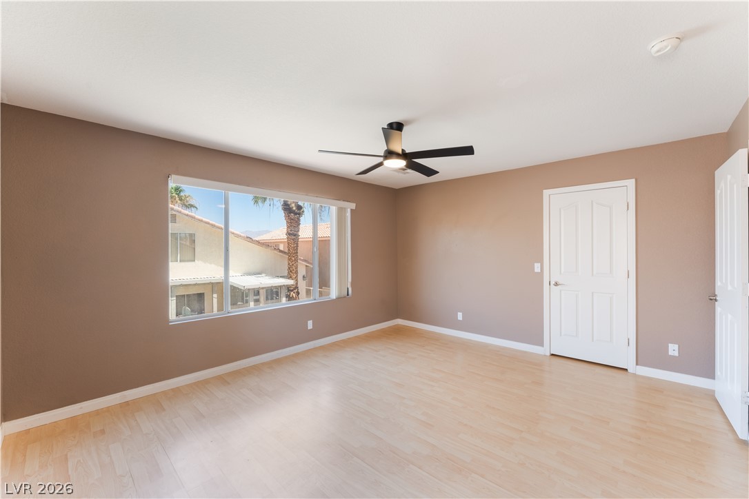 8872 Chapman Point Las Vegas, NV 89129 - Photo 14 of 29 A naturally illuminated bedroom with light-toned flooring and a window overlooking neighborhood views.
