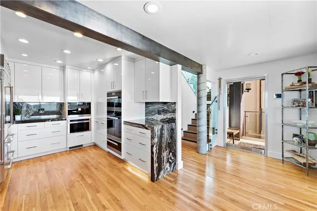a kitchen with stainless steel appliances a refrigerator and cabinets