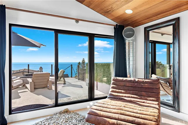 a bedroom with furniture and large windows