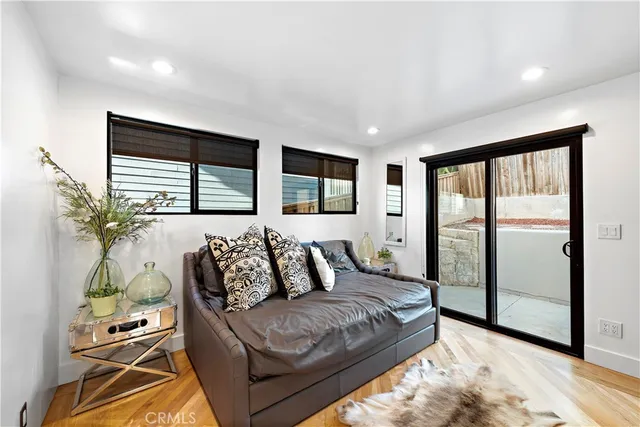 a bedroom with a bed window and mirror