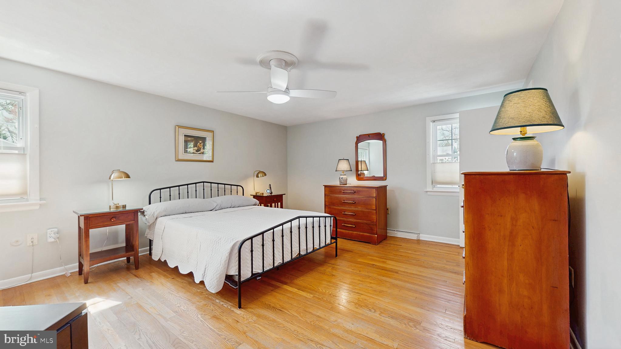 27 Farm Road Ewing, NJ 08638 - Photo 18 of 47 a bedroom with a bed and dresser with wooden floor