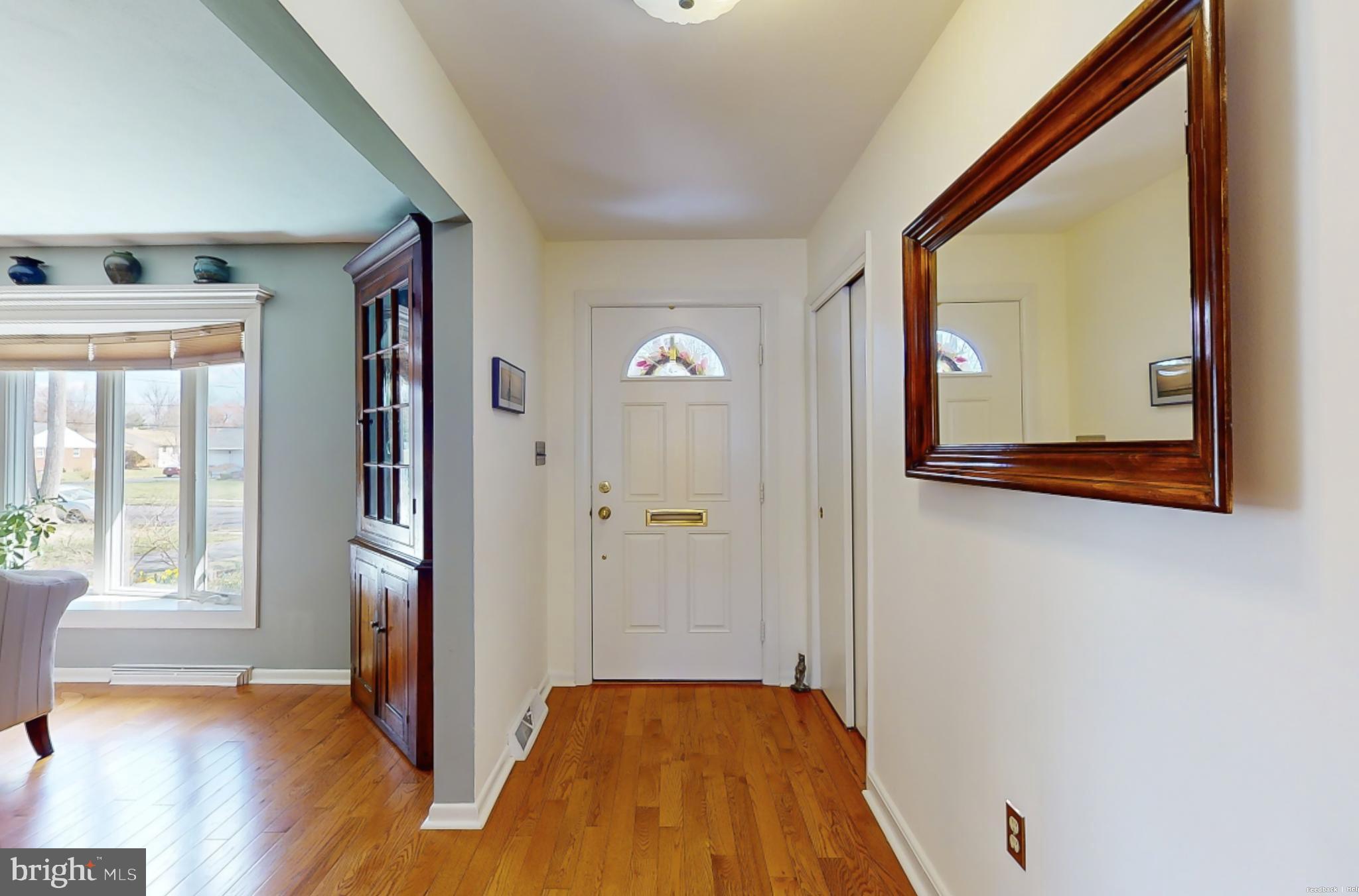 27 Farm Road Ewing, NJ 08638 - Photo 4 of 47 a view of a hallway with wooden floor and glass door