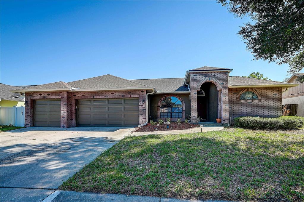 1418 Buckner Road Valrico, FL 33596 - Photo 1 of 37 a front view of a house with a yard and garage