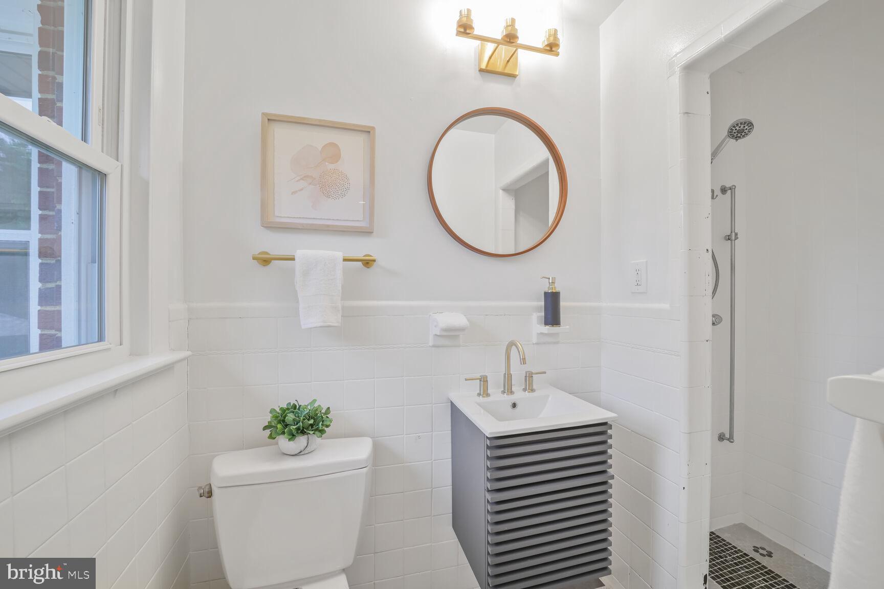 4609 22nd Avenue Mount Rainier, MD 20712 - Photo 13 of 33 a bathroom with a sink and a mirror