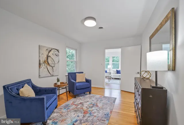 a living room with furniture and wooden floor