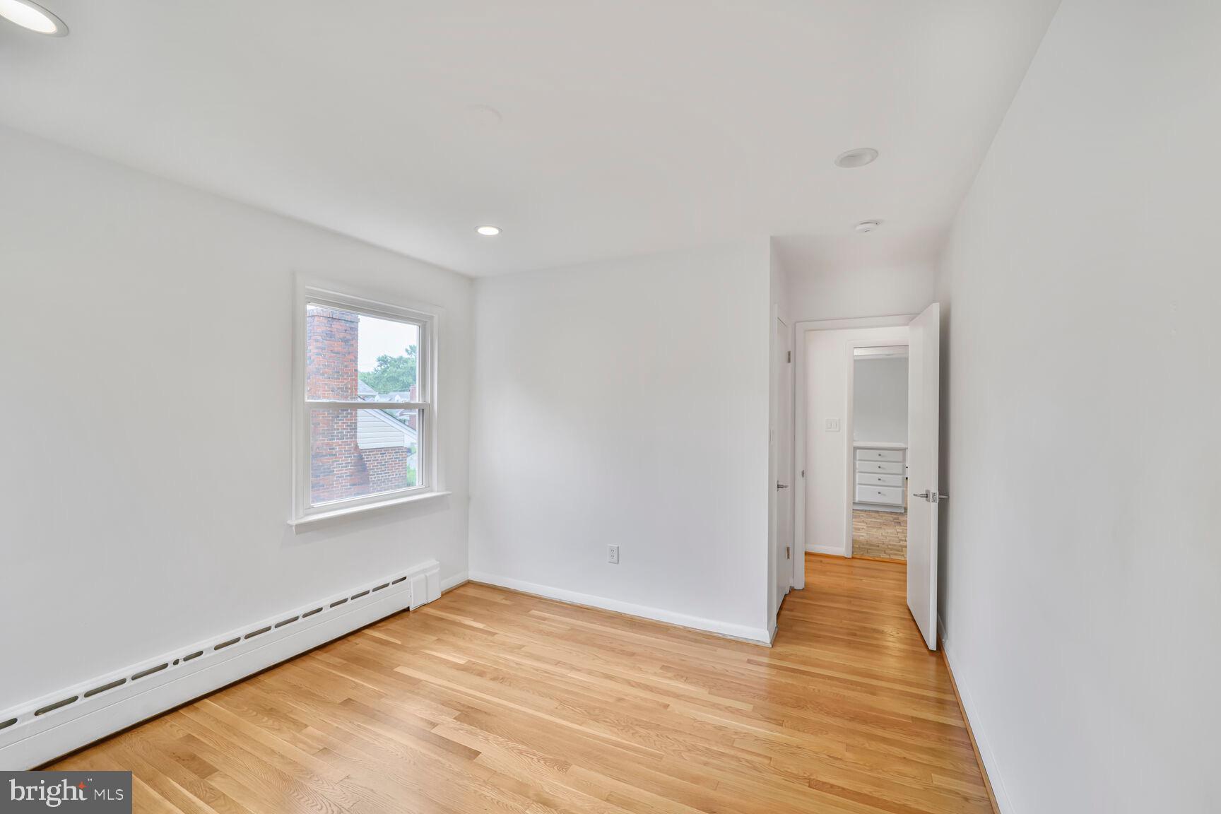 4609 22nd Avenue Mount Rainier, MD 20712 - Photo 20 of 33 a view of an empty room with wooden floor and a window