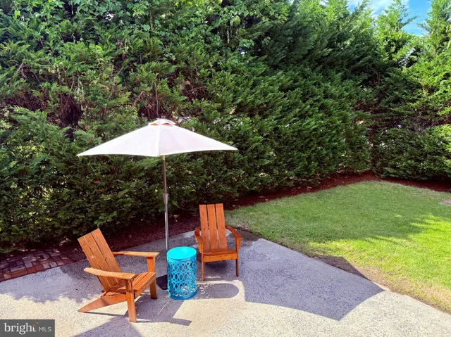 a backyard of a house with table and chairs