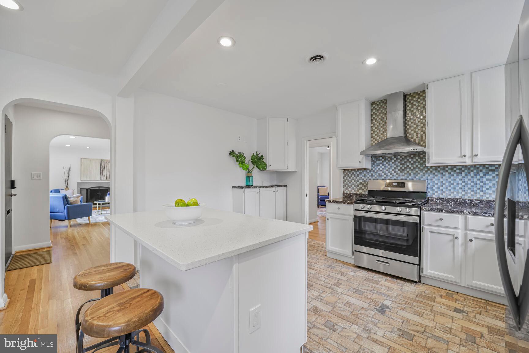 4609 22nd Avenue Mount Rainier, MD 20712 - Photo 7 of 33 a kitchen with a stove a white table and chairs