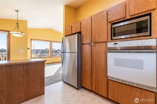a kitchen with stainless steel appliances a refrigerator stove and microwave