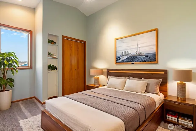 a bedroom with a bed and a potted plant