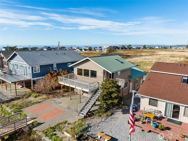 an aerial view of multiple houses with a yard