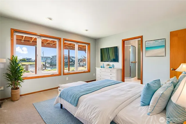 a bedroom with a bed and a potted plant