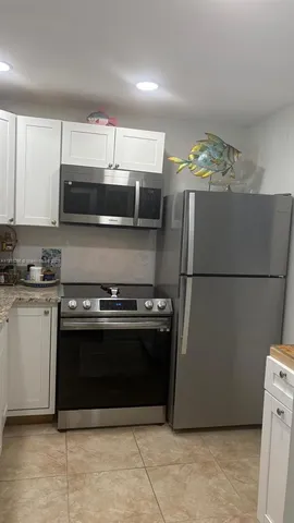 a kitchen with stainless steel appliances granite countertop a stove and a refrigerator
