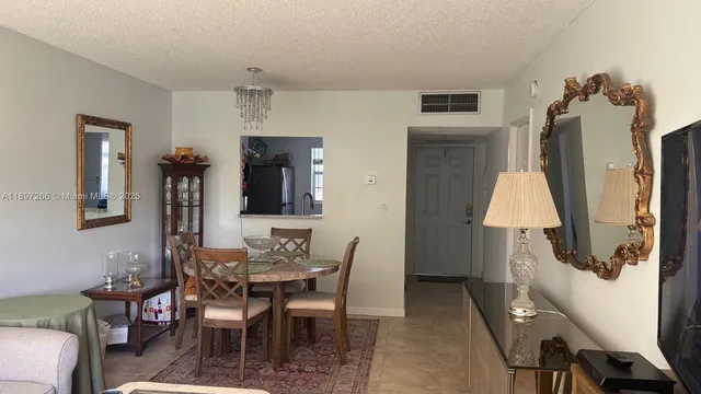 a dining room with furniture and a window