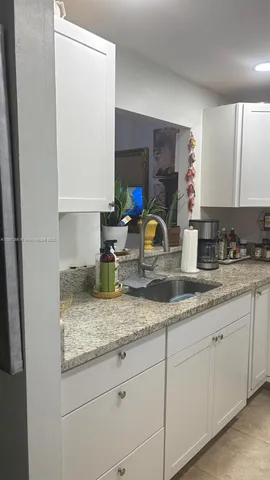 a kitchen with sink and window