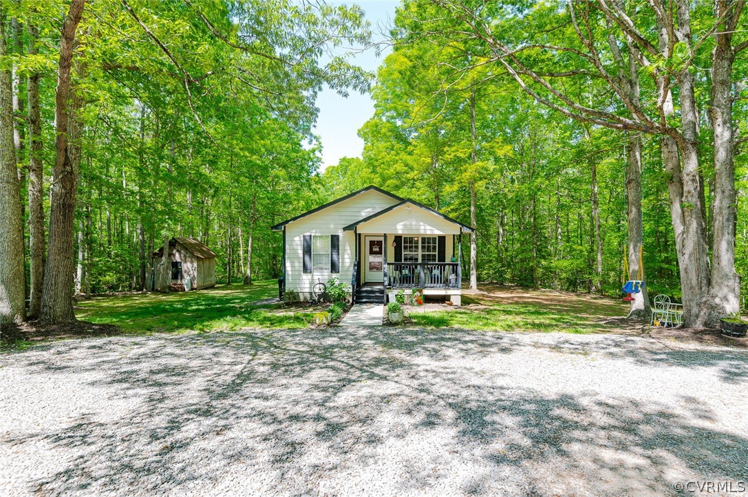 4255 Watson Road Sandy Hook, VA 23153 - Photo 2 of 27 a front view of a house with garden
