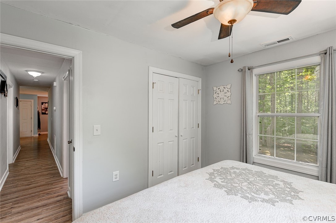 4255 Watson Road Sandy Hook, VA 23153 - Photo 23 of 27 a view of a livingroom with wooden floor and a ceiling fan