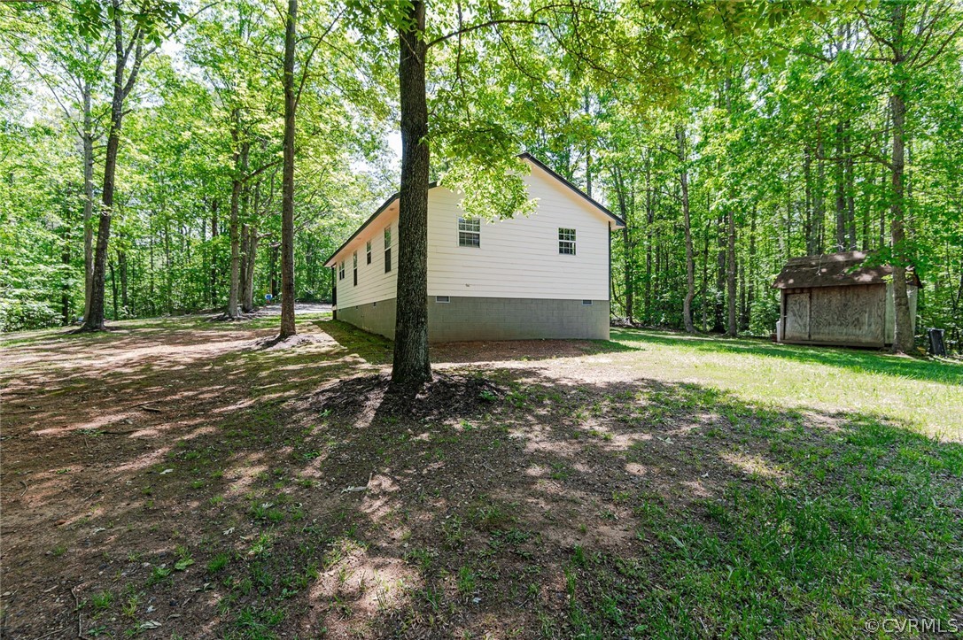 4255 Watson Road Sandy Hook, VA 23153 - Photo 27 of 27 a view of a house with backyard and trees