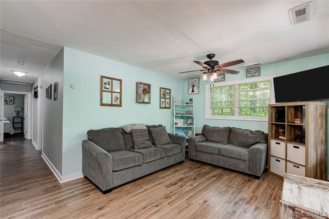 4255 Watson Road Sandy Hook, VA 23153 - Photo 6 of 27 a living room with furniture a flat screen tv and a large window