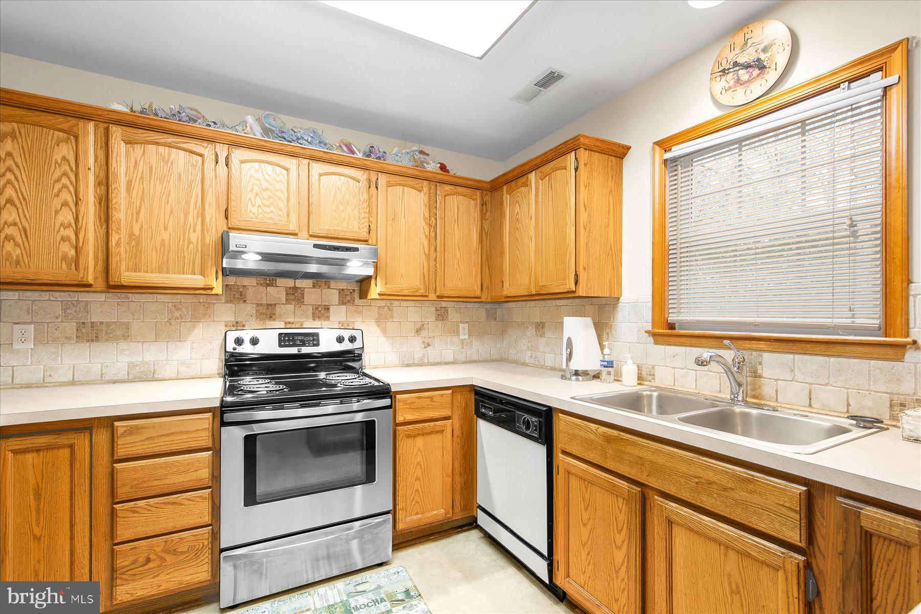 50 King Richard Road Ocean Pines, MD 21811 - Photo 12 of 28 a kitchen with stainless steel appliances a stove a sink and cabinets