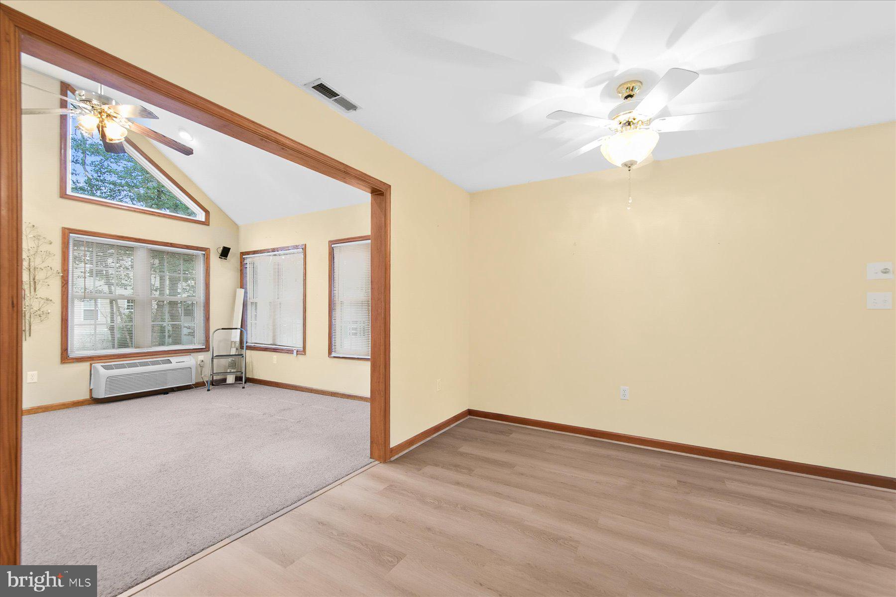 50 King Richard Road Ocean Pines, MD 21811 - Photo 15 of 28 an empty room with wooden floor chandelier fan and windows