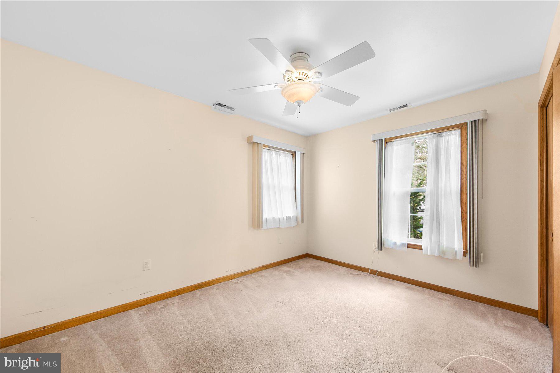 50 King Richard Road Ocean Pines, MD 21811 - Photo 21 of 28 an empty room with windows and fan