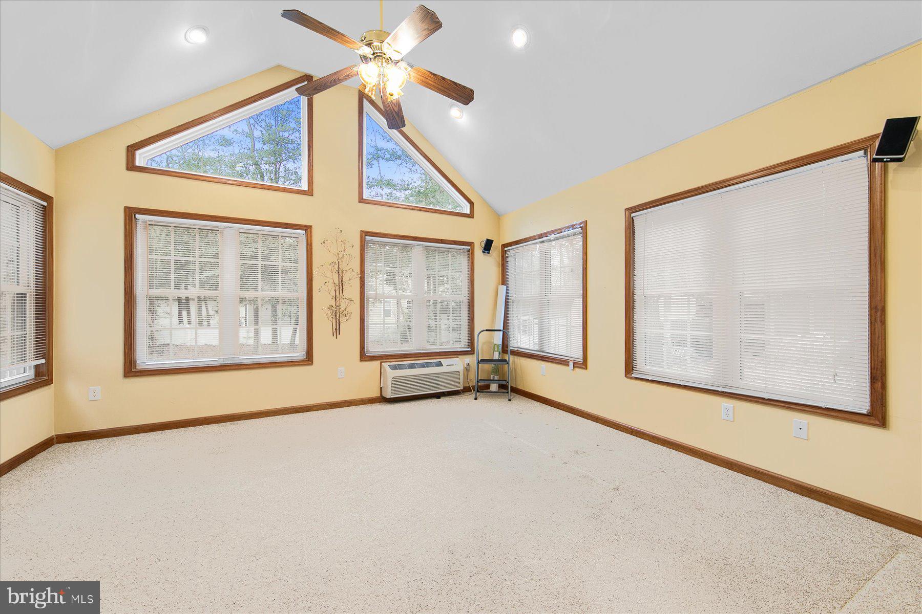 50 King Richard Road Ocean Pines, MD 21811 - Photo 5 of 28 a view of an empty room with a window and a ceiling fan