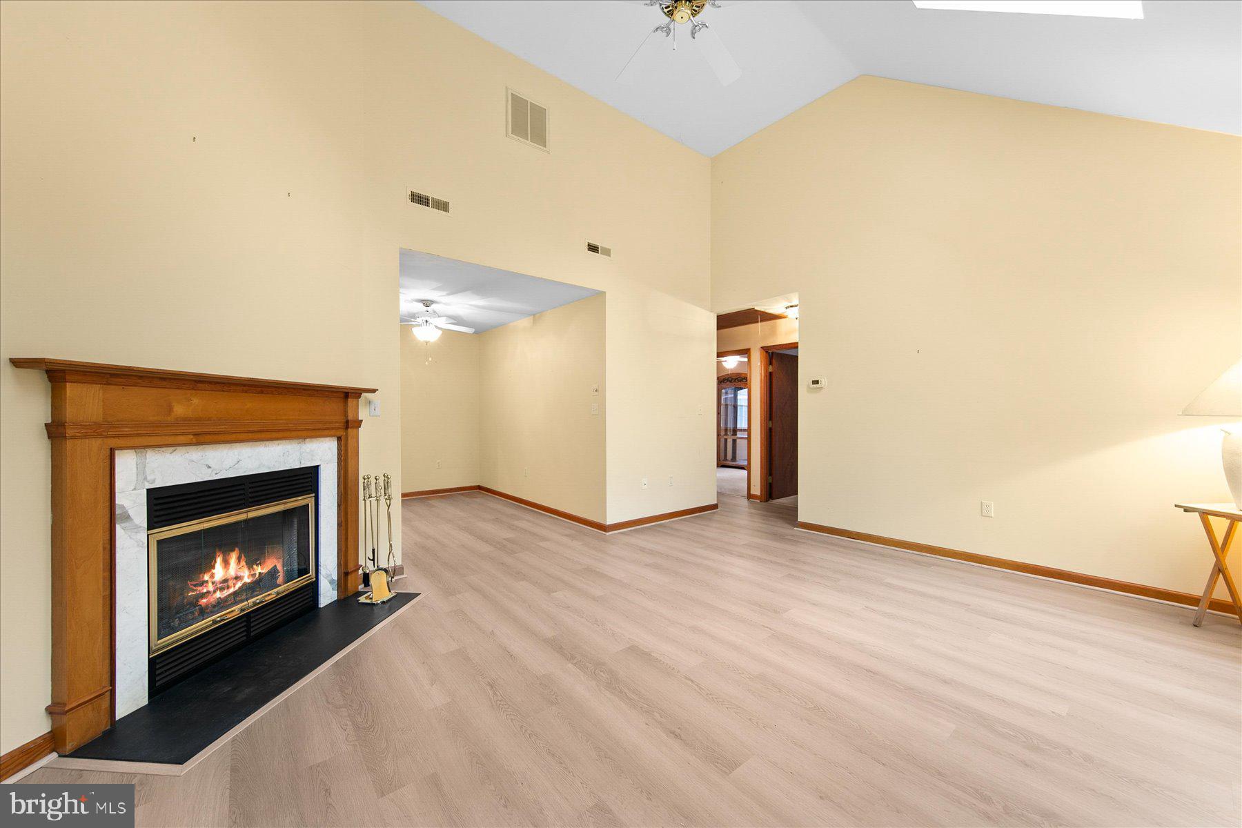 50 King Richard Road Ocean Pines, MD 21811 - Photo 7 of 28 a view of an empty room with wooden floor and a fireplace