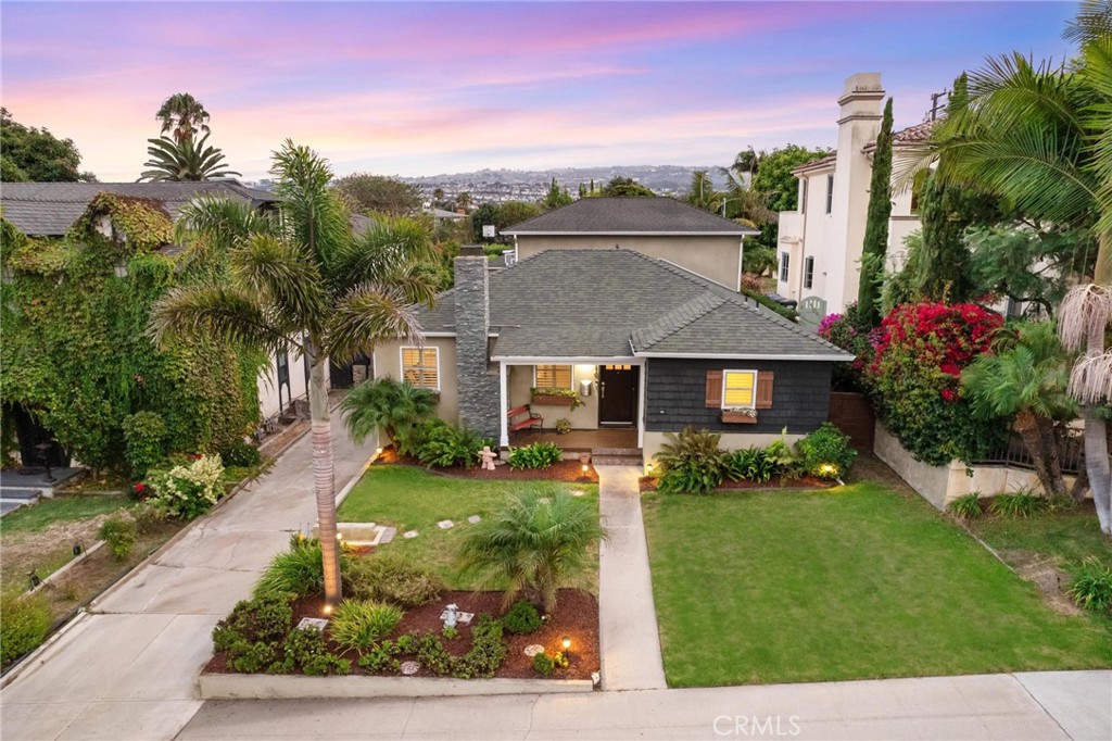 714 Avenue D Redondo Beach, CA 90277 - Photo 1 of 47 a view of a white house with a yard plants and large tree