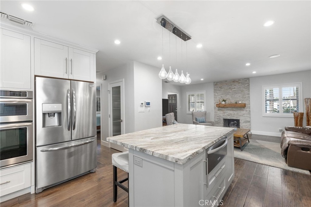 714 Avenue D Redondo Beach, CA 90277 - Photo 13 of 47 a kitchen with a refrigerator a sink dishwasher a stove and a refrigerator with wooden floor