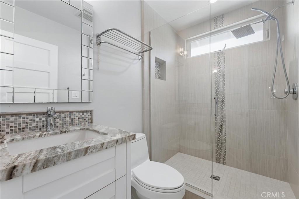 714 Avenue D Redondo Beach, CA 90277 - Photo 35 of 47 a bathroom with a granite countertop sink a toilet and shower