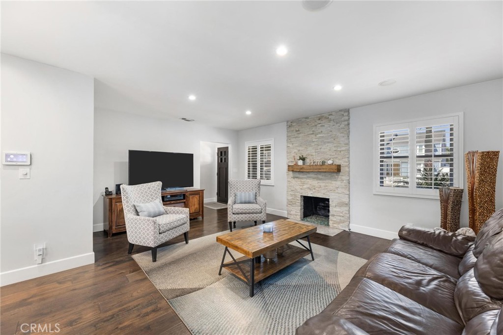 714 Avenue D Redondo Beach, CA 90277 - Photo 7 of 47 a living room with furniture flat screen tv and a fireplace