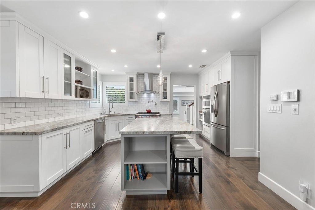 714 Avenue D Redondo Beach, CA 90277 - Photo 9 of 47 a kitchen with stainless steel appliances a dining table chairs microwave and cabinets