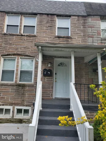 a view of a house with a small yard and swimming pool