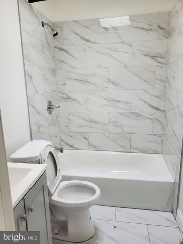 a bathroom with a toilet and a bathtub