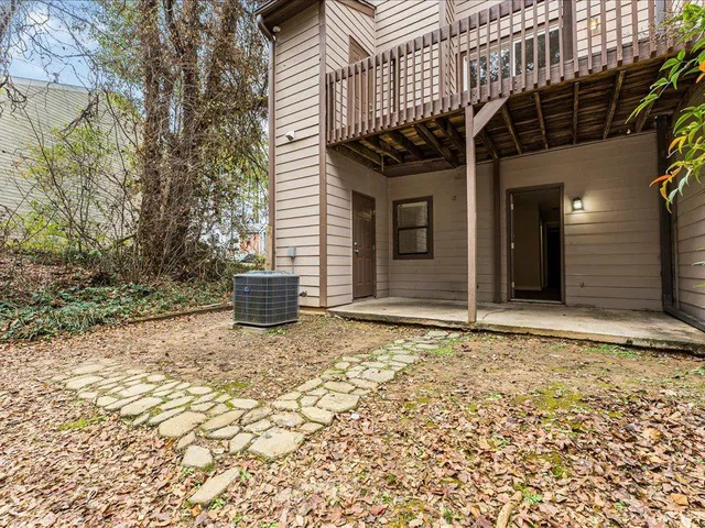 a view of a house with a backyard and floor to ceiling window
