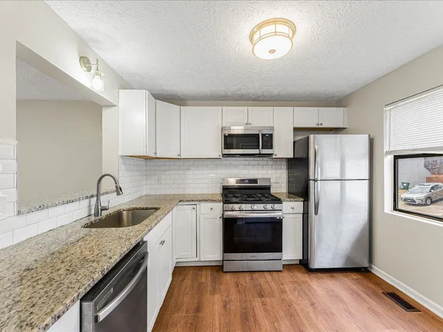 a kitchen with a sink stove and refrigerator