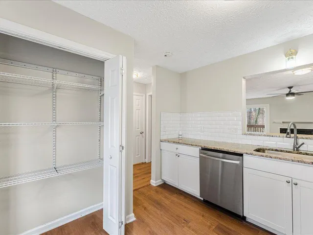 a kitchen with a sink cabinets and wooden floor