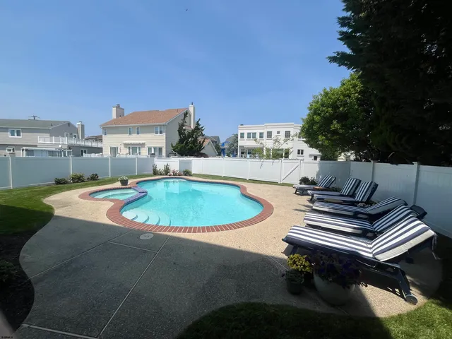 a view of a swimming pool with a patio