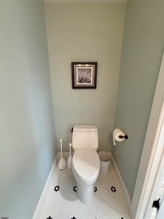 a white toilet sitting next to a shower