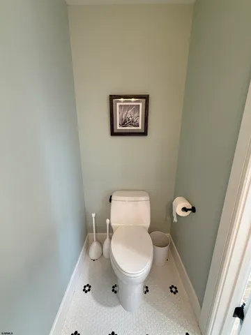 a white toilet sitting next to a shower