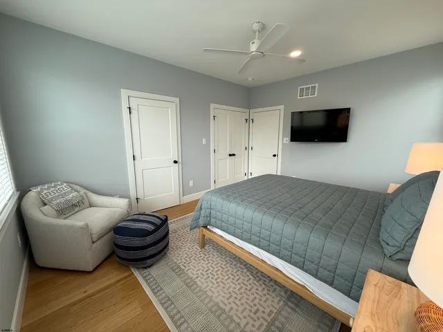 a bedroom with furniture and a flat screen tv